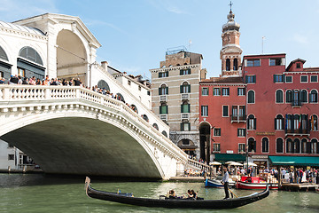 Image showing Famous Ponte di Rialto with traditional gondola passing in Venice, Italy