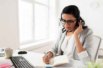 Image showing businesswoman with headset talking at office