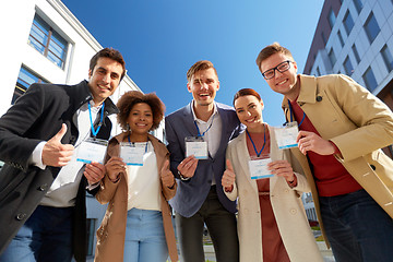 Image showing business team with conference badges in city