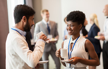 Image showing business people with conference badges and coffee