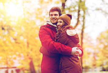 Image showing happy young couple hugging in autumn park