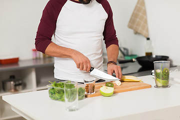 Image showing man with blender and fruit cooking at home kitchen