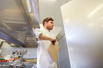 Image showing chef with clipboard doing inventory at kitchen