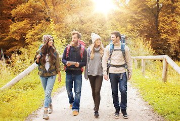 Image showing friends hiking with backpacks and tablet pc