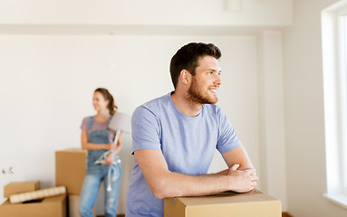 Image showing happy couple with boxes moving to new home