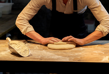 Image showing baker making bread dough at bakery kitchen