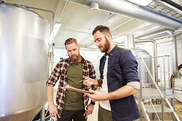 Image showing men with clipboard at brewery or beer plant