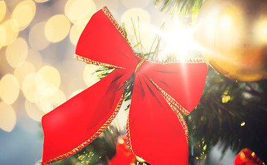 Image showing close up of red bow decoration on christmas tree