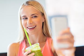 Image showing woman with smartphone taking selfie at restaurant