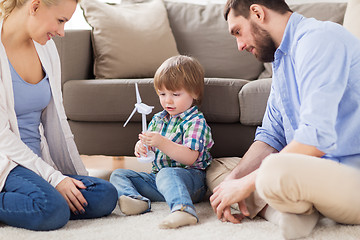 Image showing happy family playing with toy wind turbine