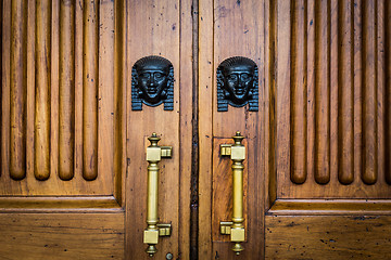 Image showing Sphinx heads entrance on wooden door