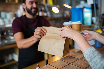 Image showing man or bartender serving customer at coffee shop