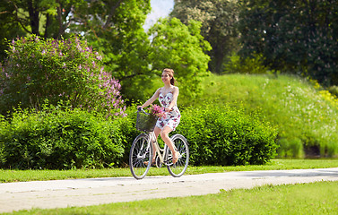 Image showing happy woman riding fixie bicycle in summer park