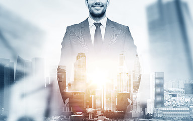 Image showing close up of happy businessman over city background