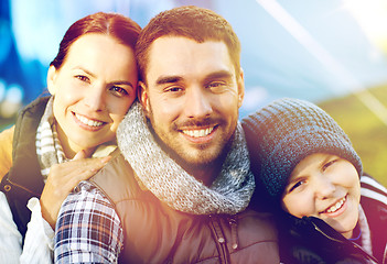 Image showing happy family portrait over tent at camp site