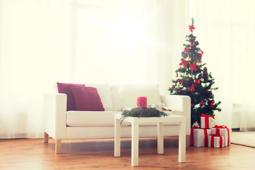 Image showing sofa, table and christmas tree with gifts at home