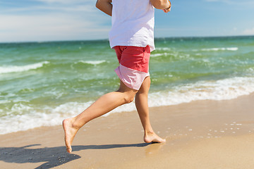 Image showing happy man running along summer beach