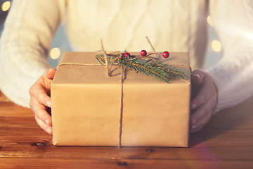 Image showing close up of woman with christmas gift or parcel