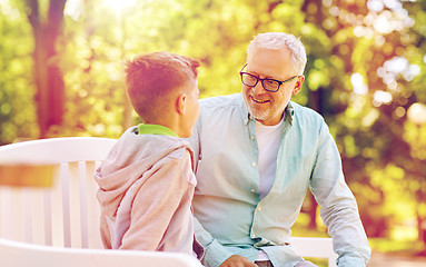 Image showing grandfather and grandson talking at summer park