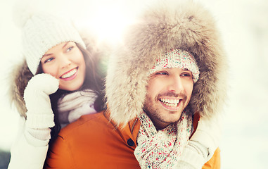 Image showing happy couple having fun over winter background