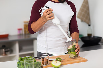 Image showing man with blender and fruit cooking at home kitchen