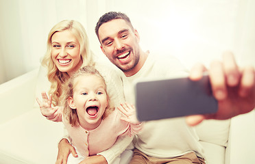 Image showing family taking selfie with smartphone at home