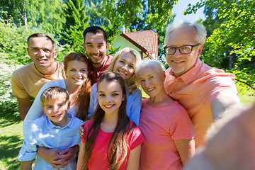 Image showing happy family taking selfie in summer garden