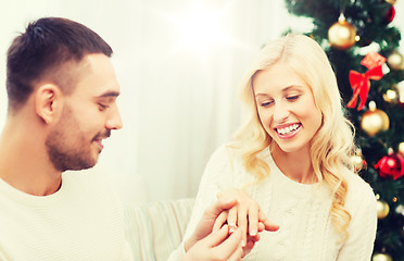 Image showing man giving woman engagement ring for christmas