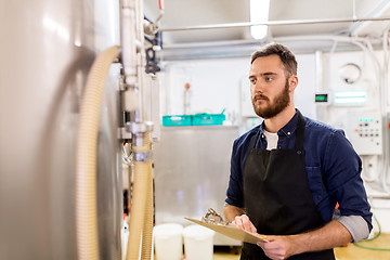 Image showing man with clipboard at craft brewery or beer plant