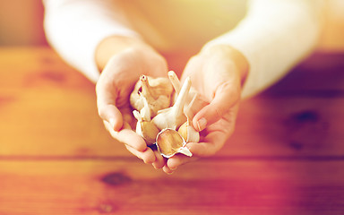 Image showing close up of woman hands holding garlic