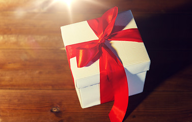 Image showing close up of christmas  gift box on wooden floor