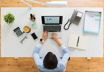 Image showing businesswoman working on laptop at office