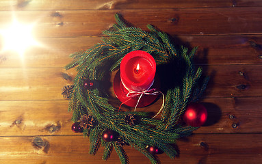 Image showing fir branch wreath with candle on wooden table