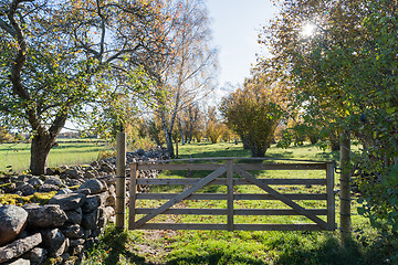 Image showing Wooden gate in a colorful landscape