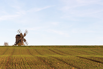 Image showing Old windmill by a farmers corn field