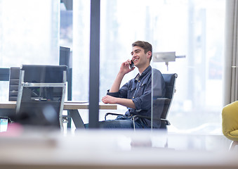 Image showing Young casual businessman using smartphone