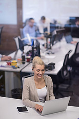 Image showing businesswoman using a laptop in startup office