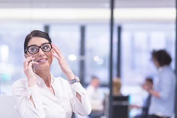 Image showing Elegant Woman Using Mobile Phone in startup office building