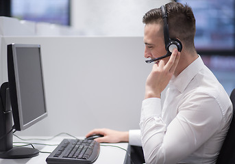 Image showing male call centre operator doing his job