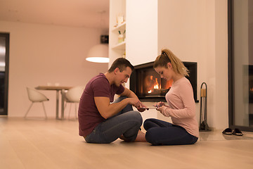 Image showing Young Couple using digital tablet on cold winter night