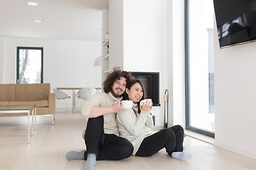 Image showing happy multiethnic couple  in front of fireplace