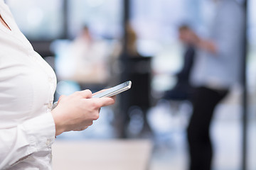 Image showing Elegant Woman Using Mobile Phone in startup office building