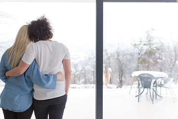 Image showing young couple enjoying morning coffee by the window