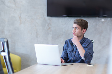 Image showing businessman working using a laptop in startup office