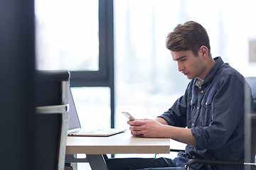 Image showing Young casual businessman using smartphone