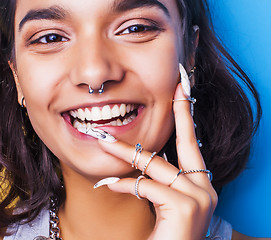 Image showing lifestyle people concept. young pretty smiling indian girl with long nails wearing lot of jewelry rings, asian summer happy cool 