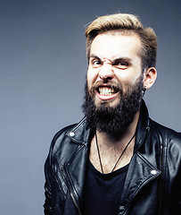 Image showing portrait of young bearded hipster guy on gray dark background close up, brutal modern man, lifestyle people concept 