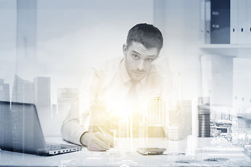 Image showing stressed businessman with laptop at office