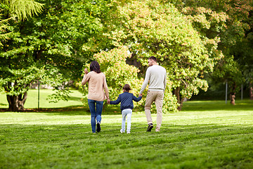 Image showing happy family walking in summer park