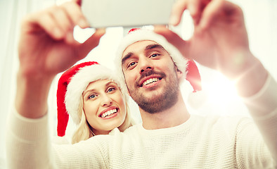 Image showing couple taking selfie with smartphone at christmas